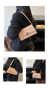 Close-up of minimalist beige baguette bag featuring a vintage golden square metal turn-lock