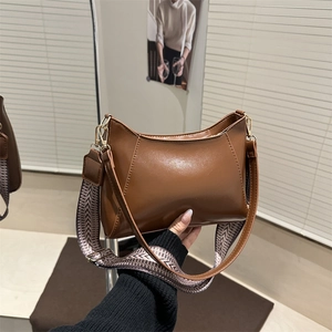 Brown vintage half-moon leather shoulder bag with stylish wide geometric fabric strap
