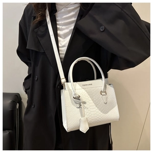 Detail of white woven texture handbag featuring Fashion & Bags logo and round handle