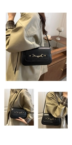 Close-up of black leather shoulder bag featuring a classic gold horsebit metal buckle