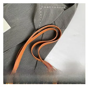 Detailed close-up of retro tote bag featuring classic M-letter pattern and leather straps