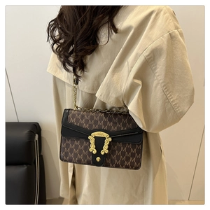 Retro monogram shoulder bag with gold baroque buckle shown on beige trench coat