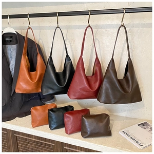 Detail view of large leather tote bag set with matching zipper pouches in four colors