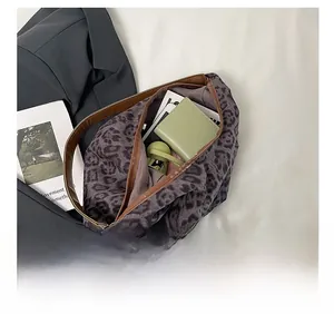 Macro view of leopard print tote bag interior capacity with brown leather trim details