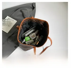Top view of brown vintage monogram tote bag showing spacious interior with daily essentials