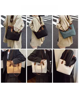 Close-up of quilted tote bags in four colors showing stitching detail and leather straps