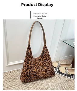Detail of leopard print tote bag with dark brown faux leather handles on a beige rug
