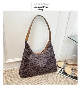 Detail of grey leopard print tote bag in frosted fabric with brown leather strap