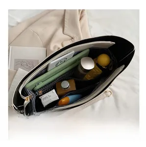 Top view of the spacious interior with multiple compartments and striped lining of this tote bag