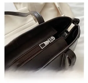 Top-down view of the smooth chocolate brown leather tote with a secure silver metal zipper