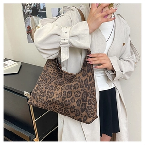 Close-up of leopard print tote bag on shoulder showing large capacity and soft fabric