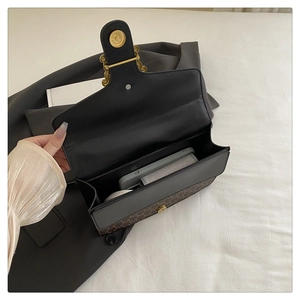 Detail view of the bag's interior showing a gold magnetic buckle and ample storage space