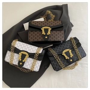Three vintage chain shoulder bags in brown, white, and black with embossed M patterns