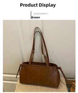 Detail view of brown PU leather shoulder bag featuring drawstring side and metal hardware