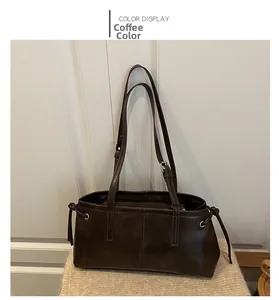 Macro shot of coffee brown vintage leather bag with adjustable strap and side drawstring