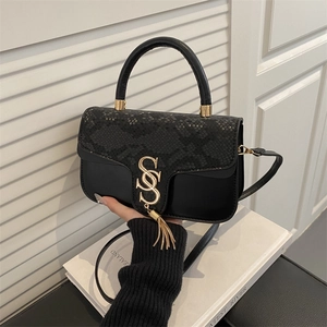 Fashionable black leather handbag with snake pattern texture and gold logo tassel decoration