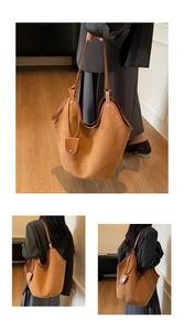 Detail of camel felt tote bag showing dual leather straps and side pendant accessory