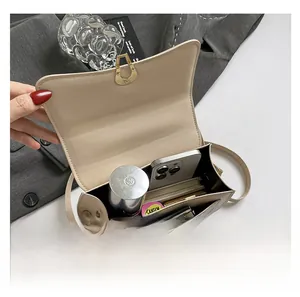 Internal view of a chic small square crossbody bag showing storage space for daily items