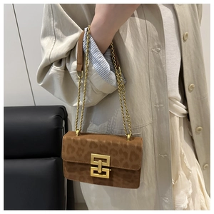 Close-up of vintage leopard print crossbody bag with gold chain strap and metal lock