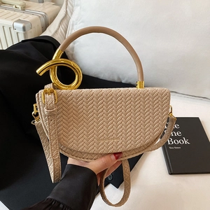 Beige woven saddle bag with circular gold handle and stylish herringbone texture