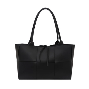 Large black woven leather tote bag with dual handles and elegant tie closure