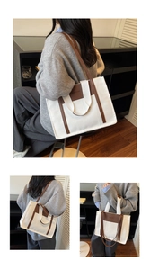 Detail of canvas tote bag with leather trim and dual handles in minimalist interior