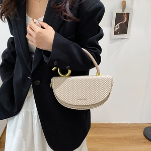 Fashionable beige woven saddle handbag with gold metal ring handles and leather strap