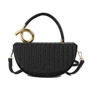 Black woven half-moon saddle bag with a unique gold spiral metal handle and thin strap