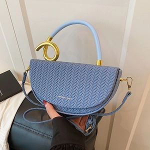 Chic fog blue woven half-moon saddle bag with round gold metal ring handle and crossbody strap