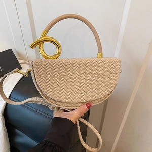 Chic beige woven saddle bag with unique gold spiral metal handle and crossbody strap