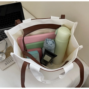 Spacious interior of canvas tote bag showing laptop, umbrella and daily essentials