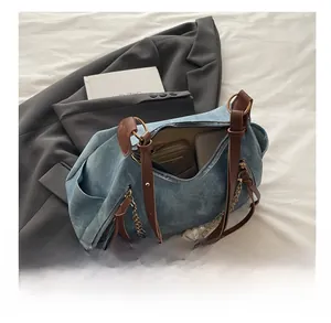 Detail of blue denim tote interior showing spacious capacity for wallet and phone