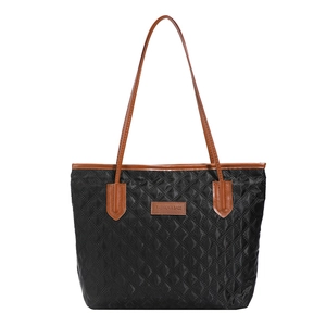 Quilted tote bag in black with brown handles and spacious diamond pattern design