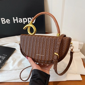 Brown woven leather saddle bag with gold ring handle and detachable shoulder strap