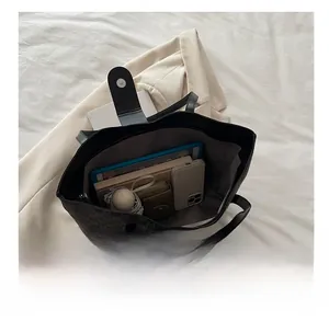 Interior view of monogram tote bag showing large capacity for tablet and essentials