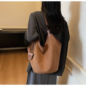 Sac seau marron dépoli grande capacité avec pochette latérale porté par le modèle