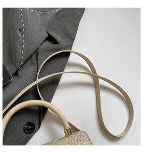 Detailed close-up of champagne glitter texture with leather straps and gold metal hardware