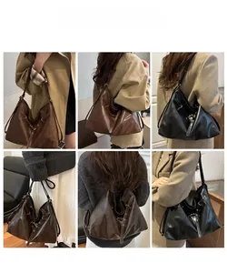 Detail view of large vintage hobo tote bag in black and dark brown synthetic leather