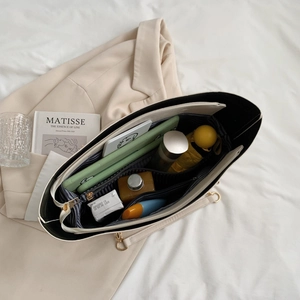 Large off-white PU tote bag with spacious interior and blue striped lining storage
