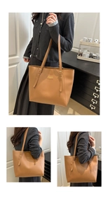 Détail d'un grand sac cabas marron avec bandoulières réglables et finitions dorées