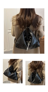 Close-up of flexible black leather backpack with adjustable straps and metallic buckles