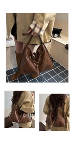 Detail of vintage large tote showing convertible straps and polished brown texture