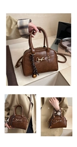 Detail of a brown retro shell bag with horsebit metal hardware and woven tassel charms