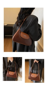 Detail view of brown crocodile texture shoulder bag with silver bow buckle on flap