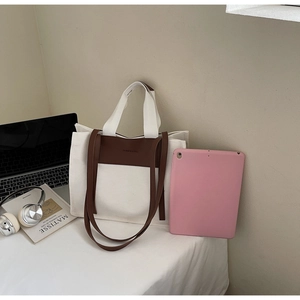 Canvas and leather patchwork tote bag showing large capacity with fashion and bag text