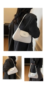 Detail showing white crocodile embossed leather bag with silver metal bow accent