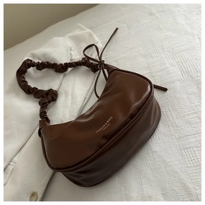 Detailed view of dark brown pleated cloud bag with soft PU leather and bow decoration