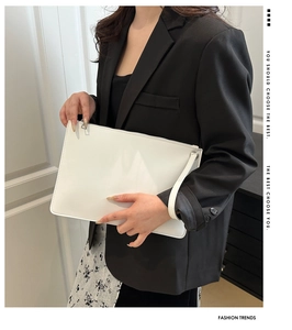 Detailed close-up of a white minimalist tote bag with smooth texture and wrist strap