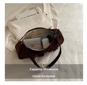 Interior view showing the storage capacity of the dark brown suede underarm bag