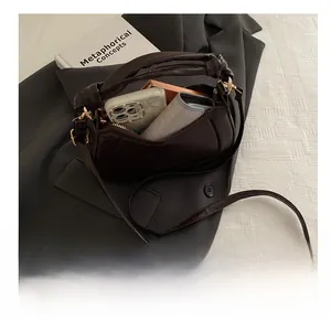 Deep brown leather handbag interior showcasing storage capacity for phone and wallet